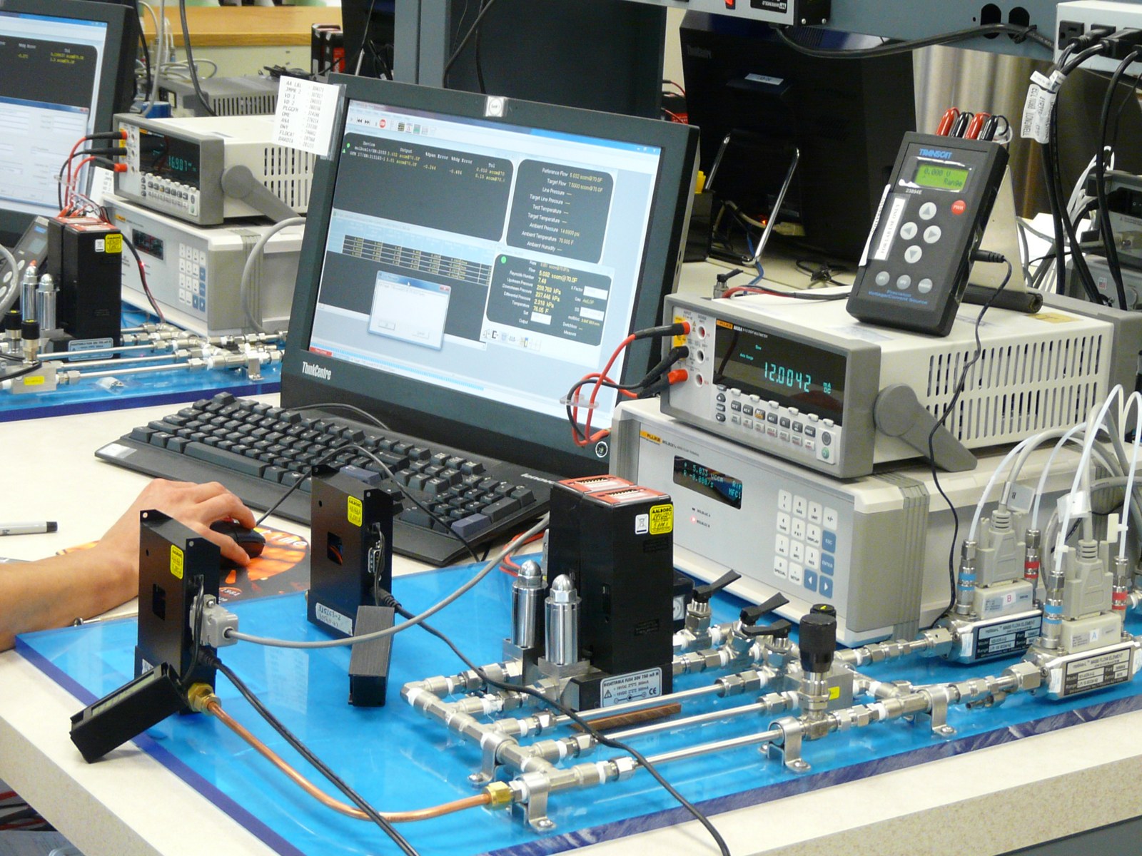 Aalborg mass flow controllers on a calibration manifold at the Aalborg factory