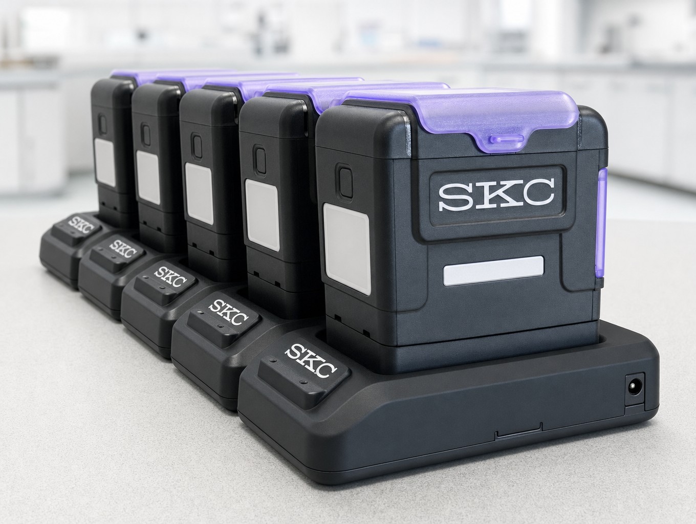 Five AirChek Touch pumps lined up in a linked charging cradle